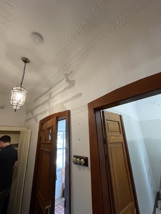 Hallway Interior Painting Sydney - Before Interior hallway before painting in Sydney showing wall repairs and unfinished plaster work