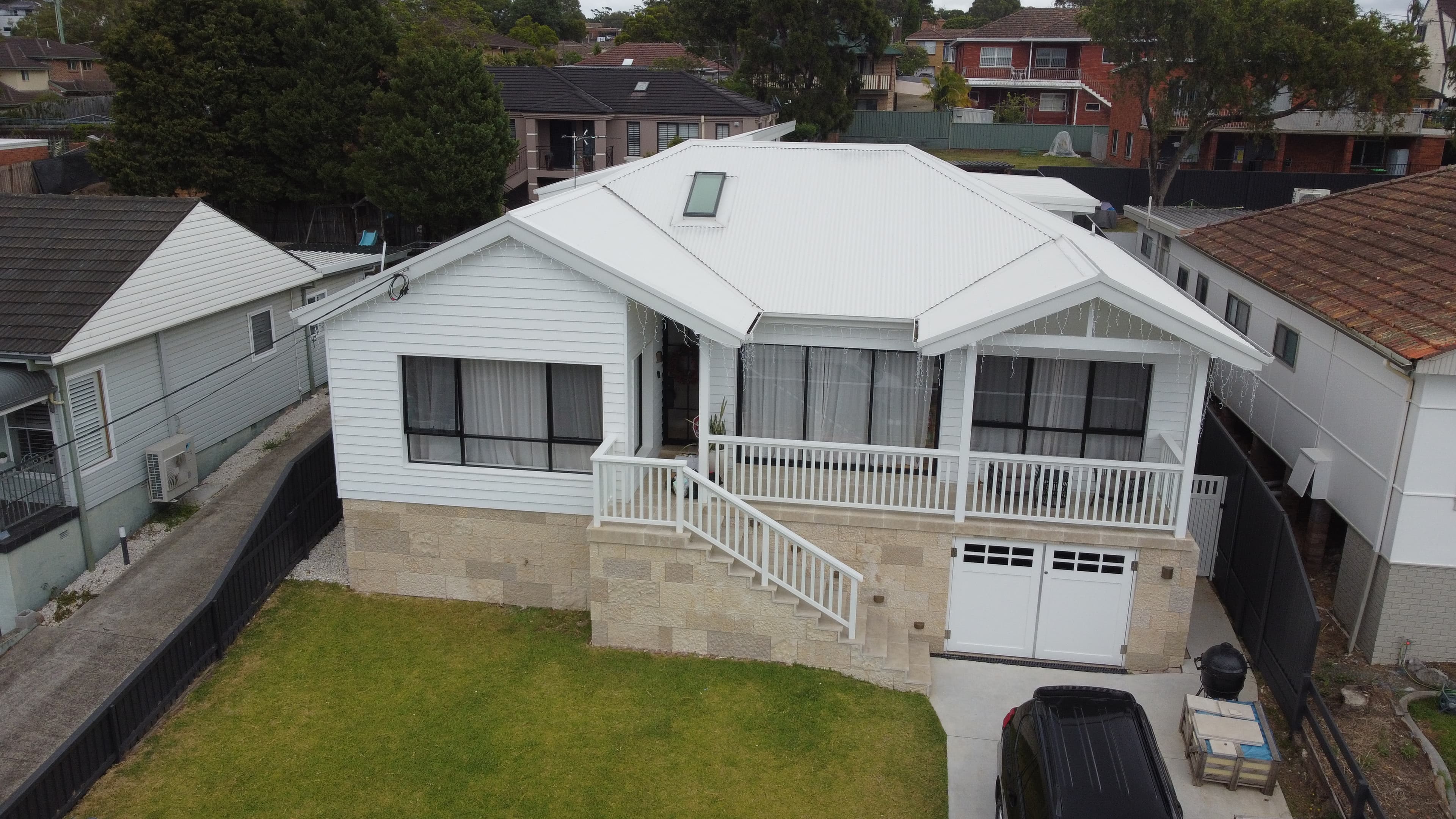 Exterior House Repainting Sydney - After House exterior after professional repainting in Sydney with clean white weatherboard finish