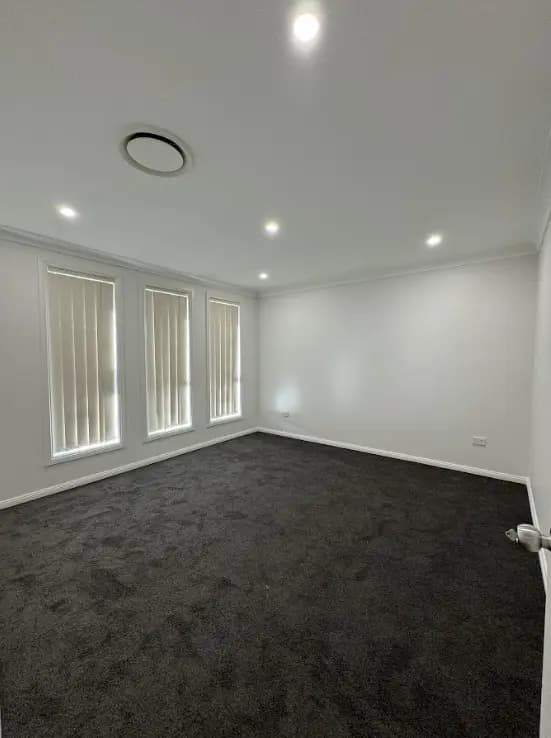 Interior wall preparation and sanding before painting in a Sydney home